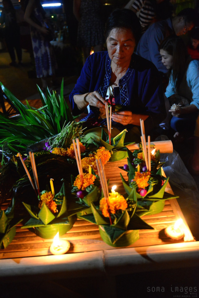 woman creating floating lanterns Loy Krathong 2014